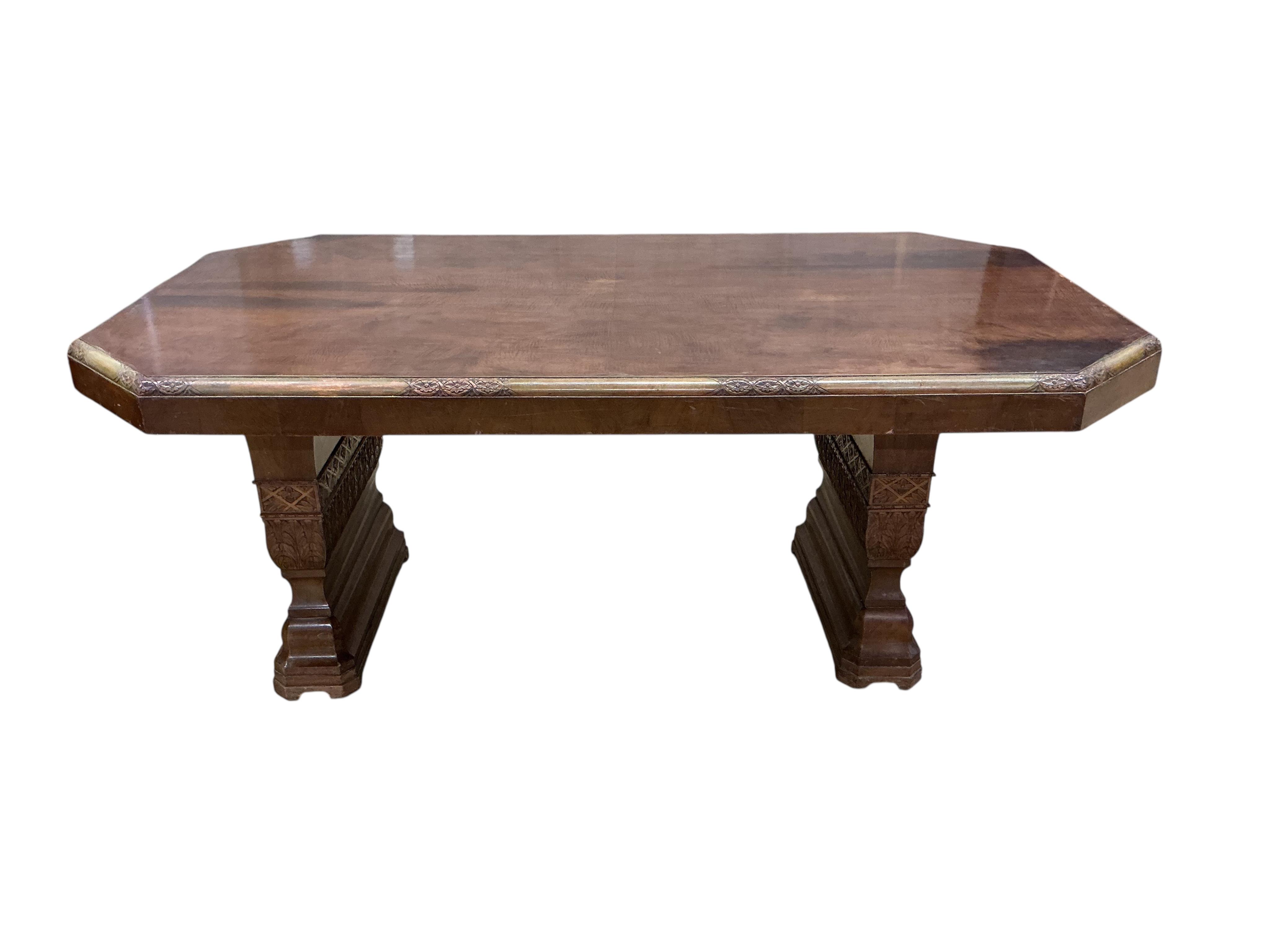 An Art deco walnut dining suite, comprising: dining table, width 190cm, depth 110cm, height 80cm together with eight chairs (two being carvers) and a bow front sideboard